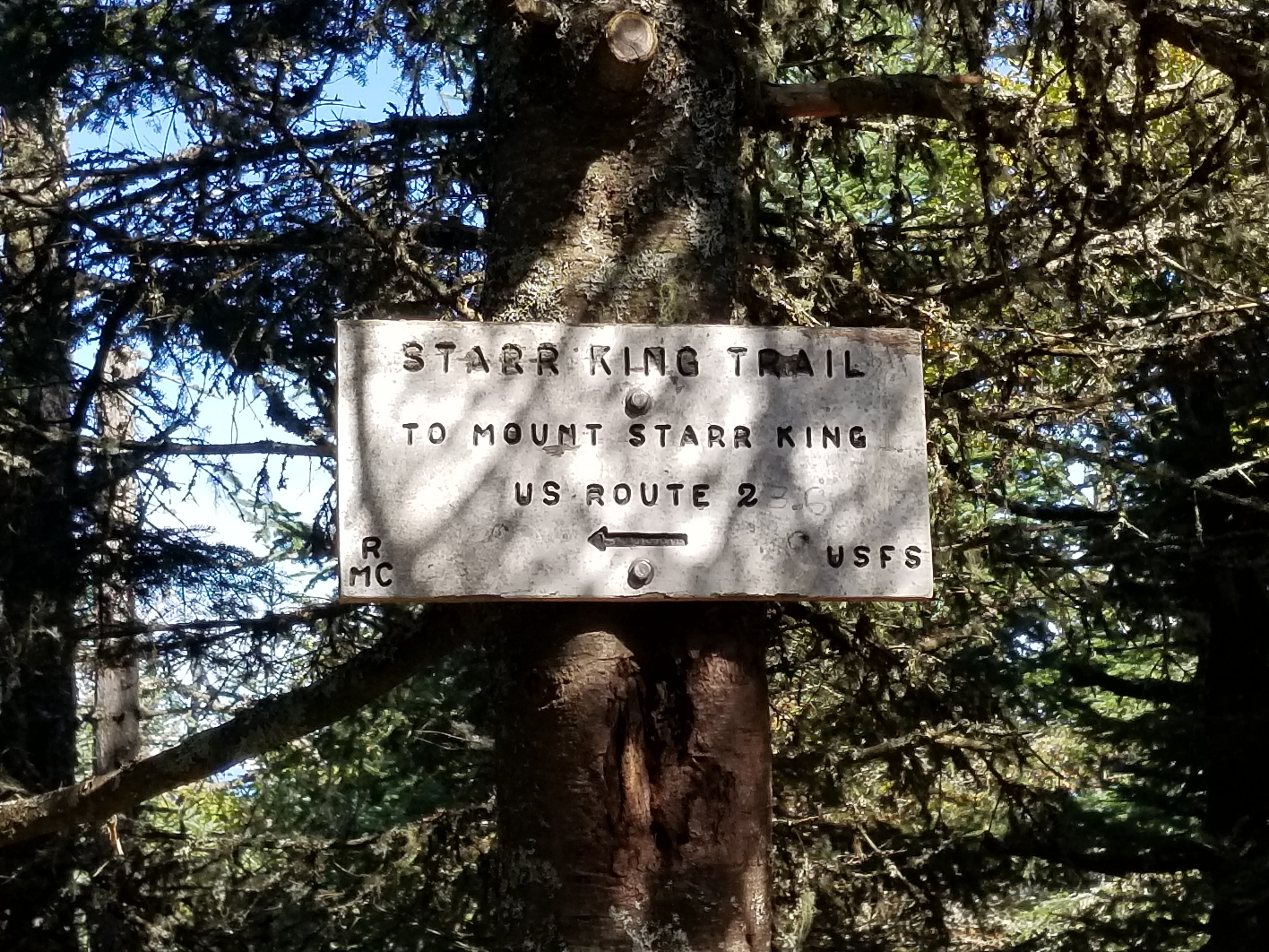 A sign at the summit pointing back to Mt. Starr King